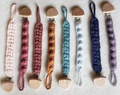 six crocheted wooden spoons lined up next to each other