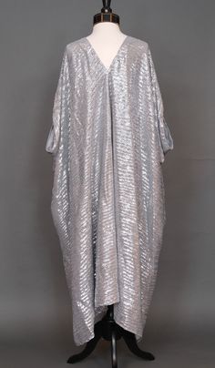 This monochromatic caftan is the answer to glam layering. Made with a stunning platinum silver sequined soft mesh fabric and lots of love. Bohemian splendor, handmade in California.Dry clean suggested to preserve the lovely sequins.One size fits all, approximately 50" long. Long Sequined Kaftan For Party, Elegant Sequined Kaftan For Evening, Elegant Evening Kaftan With Sequins, Elegant Abaya With Sequins For Party, Elegant Sequined Abaya For Party, Luxury Traditional Sequin Kaftan, Sequined Long Sleeve Evening Kaftan, Festive Long Sleeve Sequined Kaftan, Luxury Sequined Maxi Kaftan