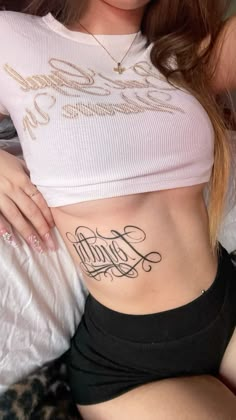 a woman with a tattoo on her stomach