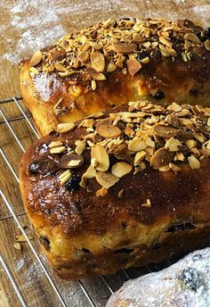 two loaves of bread sitting on top of a cooling rack