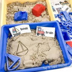 two trays filled with sand and some toys