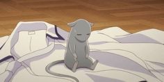 a cartoon cat sitting on top of a bed next to a wooden floor with white sheets