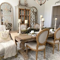 a dining room table with chairs and candles