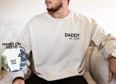 "This super cute and trendy Dad sweatshirt would be perfect for a Father's Day gift, Birthday gift, Christmas gift or anytime throughout the year, either way you they be amazingly comfortable and stylish! ♥ UNISEX CREWNECK SWEATSHIRT ♥ You will need to add each sweater individually to your cart and go through the personalization process for each to specify your required notes for each :)     ♥ HOW TO ORDER ♥ 1. Make selections from the required drop down menus 2. Leave ALL details/information needed to complete your order in the personalization box at checkout! (MISSING DETAILS WILL DELAY YOUR ORDER, PLEASE DOUBLE CHECK :) 3. Click \"ADD TO CART\". ♥ VINYL COLOR OPTIONS ♥ BLACK WHITE ♥ SHIPPING AND PROCESSING TIME ♥ Please see \"Estimated arrival\" Date near the \"Shipping and Return Polic Father's Day White Sweatshirt Gift, White Graphic Print Sweatshirt For Father's Day, Father's Day White Graphic Print Sweatshirt, Father Gift, Tshirt Bag, Kids Names, Dad Gifts, New Dads, Vinyl Colors