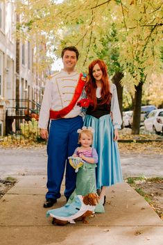 a man, woman and child dressed up as disney characters