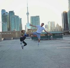 two people are jumping in the air with their feet up and one person is running