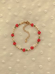 "This bracelet features red flowers.  colors: cream, red, greens, and 24k gold plated seed beads. Length: 6-8 inches Seed Bead Size: 11/0, 6/0 Adjustable: Each bracelet has a 2\" gold filled lobster clasp extender Strung on: Non-Stretchy Beading Thread" Red Seed Bead Jewelry, Cherry Seed Bead Bracelet, Bracelets With Seed Beads, Red Seed Bead Bracelet, Red Beads Bracelet, Christmas Seed Bead Bracelets, Bead Pattern Ideas, Homemade Bracelets With Beads, Cute Seed Bead Bracelets