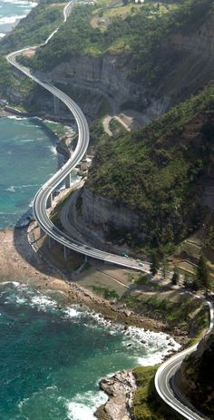 an aerial view of a highway next to the ocean