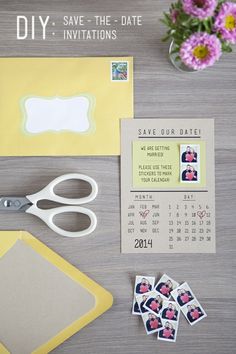 a pair of scissors sitting on top of a table next to some stickers and paper