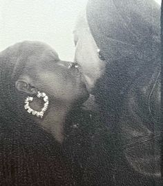 two people kissing each other in front of a black and white background with the words love written on it