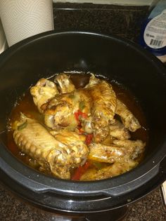 some chicken is cooking in a slow cooker