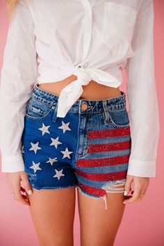 Show off your patriotic side with these American Flag Denim Shorts! Made from distressed denim, these shorts feature bold red rhinestone stripes, silver star patches, and a unique touch of blue paint. Perfect for any summer celebration or just adding some extra flair to your outfit! This is a made-to-order item. All cu Star Patches, Summer Celebration, Red Rhinestone, Blue Paint, Silver Stars, Distressed Denim, American Flag, Yves Saint Laurent, Denim Shorts