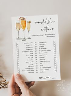 a person holding up a card with champagne glasses and the words world she wants to drink