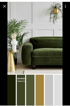 a living room with green couches, gold accents and potted plants on the wall