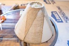 a table topped with a glass top covered in burlap