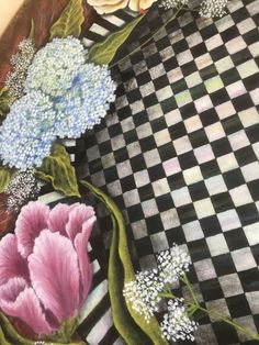 a painting of flowers on a checkered table cloth