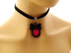 "Gothic choker Goth necklace Gothic jewelry Goth jewelry Gift for her Red Rose Black Cameo Necklace on Black Velvet choker Matching ring Gothic red rose cameo on a black background, set in a black acrylic bow tie topped frame. The cameo hangs from a velvet choker with a silver toned extender chain adjustable from 12.5 to 14.25 inches Cameo pendant - 2 inches Velvet choker necklace: 12.5-14.24 inches Arrives with a Marty White card in a lovely decorative bag and bubble wrap packaging. Facebook: h Gothic Adjustable Choker For Valentine's Day, Adjustable Gothic Choker For Valentine's Day, Adjustable Red Gothic Jewelry, Gothic Red Jewelry Gift, Red Gothic Jewelry For Gift, Red Gothic Jewelry Gift, Red Emo Jewelry For Party, Adjustable Gothic Necklace For Gifts, Gothic Choker Jewelry For Valentine's Day