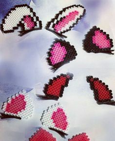 several hearts are arranged in the shape of small pixeles on a white tablecloth