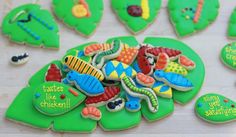 decorated cookies are sitting on top of green leaves