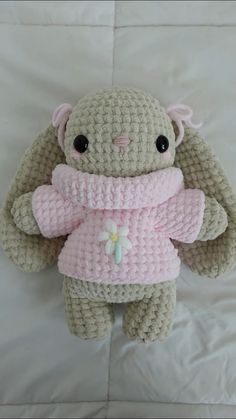 a crocheted stuffed animal wearing a pink sweater