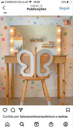 a table with a mirror and lights on it in front of a polka dot wall