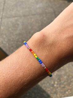 Dainty, stretchy rainbow seed bead bracelet. Sizing tip: my wrist (shown in the picture) fits best with a 6.5 inch bracelet. Lgbtq Bracelet, Braided Bracelet Diy, Pride Bracelet, Seed Bead Bracelet, Rainbow Bracelet, Bracelet Dainty, Rainbow Beads, Seed Bead Bracelets, Photo Bracelet