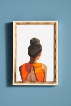 an image of a woman's head in a frame on a blue wall