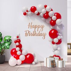 a happy birthday balloon arch with red and white balloons