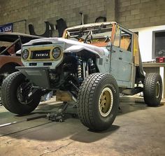 an off - road vehicle is parked in a garage