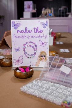 a table topped with lots of jewelry and greeting cards next to donuts on top of it