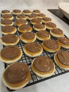 there are many cookies with chocolate frosting on the cooling rack