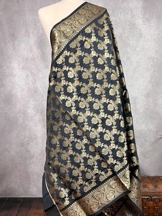 Beautiful Black Banarasi Soft Silk Dupatta with Zari Weaved with flower designs all over the dupatta. Item: DupattaBase color : Black Fabric : Banarasi Silk (Non-Pure Silk)Work : Zari Weaved with tasselsWidth of the dupatta - 35 inches (approx)length of the dupatta - 88 inches (approx)Store Policies- No return or exchange will be accepted for color variations.- No return or exchange will be accepted if the color does not match your other clothing or your partners or anyone else.- Since this Dupa Festive Black Dupatta With Woven Motifs, Festive Black Traditional Wear With Woven Motifs, Traditional Black Dupatta With Woven Motifs, Black Dupatta With Woven Motifs For Diwali, Facebook Black, Stole Scarf, Nehru Jackets, Readymade Blouse, Zari Work