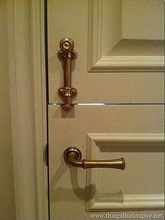 an open door with brass handles and knobs