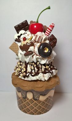 an ice cream sundae is topped with chocolate, cherries, and marshmallows