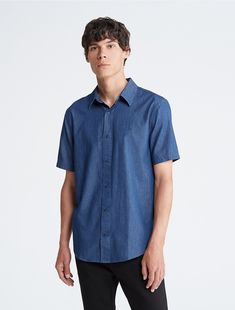 A refined silhouette with considered detailing, this woven shirt is cut in a regular fit with classic chambray cotton. Designed with an iconic monogram logo at the chest for an elevated and versatile Calvin Klein essential.  Material: 100% Cotton. Modern Business Shirt For Summer, Cotton Slim Fit Short Sleeve Dress Shirt, Formal Short Sleeve Cotton Shirt, Short Sleeve Cotton Shirt For Business, Classic Relaxed Fit Short Sleeve Shirt For Business Casual, Formal Cotton Shirt With Short Sleeves, Modern Shirt With Welt Pockets, Classic Short Sleeve Shirt With Relaxed Fit, Classic Solid Short Sleeve Shirt With Relaxed Fit