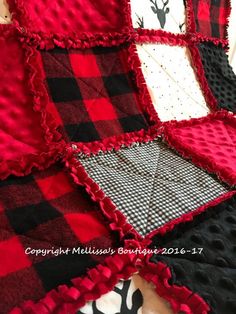 a red and black quilt with deer head on it