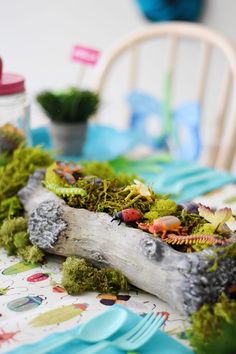 the table is covered with moss and little toys