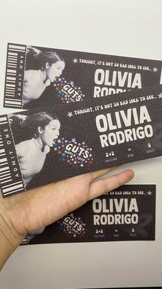 someone is holding two concert tickets in their hand with the words ollivia rodigio on them