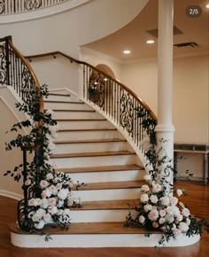 a staircase decorated with flowers and greenery