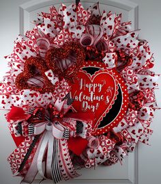 a red and white valentine's day wreath on a door