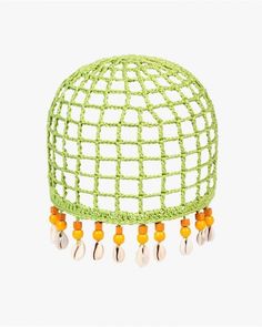 a green netted object with beads hanging from it's sides