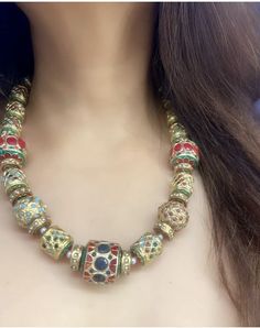 A colorful Navratan necklace from Punjab is a traditional piece of jewelry adorned with nine different gemstones, each representing one of the nine planets according to Hindu astrology. These gemstones, known as Navratna or Navaratna, typically include diamonds, rubies, emeralds, sapphires, pearls, coral, topaz, cat's eye, and garnet. The necklace is designed to bring good fortune and balance to the wearer's life, reflecting cultural beliefs and aesthetic preferences. Navratan necklaces are prized for their intricate craftsmanship and spiritual significance, making them a cherished part of Punjab's cultural heritage and adornment traditions. Temple Jewelry Necklaces With Colorful Beads For Celebration, Temple Jewelry Necklace With Colorful Beads For Celebration, Bohemian Gold Bridal Necklace With Polished Beads, Traditional Multicolor Polished Beads Jewelry, Traditional Multicolor Necklace With Faceted Beads, Traditional Beaded Necklace For Festive Occasions, Traditional Long Beaded Necklaces With Gold Beads, Bohemian Bridal Necklace With Round Beads For Celebration, Bohemian Beaded Necklaces With Faceted Beads For Celebration