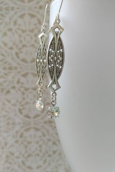 Textured Front, Hollow Back These 1920s inspired earrings feature silver plated Art Deco style brass connectors and sparkling clear Swarovski crystal beads. The dainty brass connectors are very lightweight yet sturdy and slightly hollow on the reverse side. (SEE 2nd PHOTO) They remind me of delicate Edwardian lace. They measure 2 1/2 inches long from the top of the silver plated lever back ear wires to the bottom of the crystal beads An elegant combination for a vintage inspired wedding. ABOUT T Classic Filigree Chandelier Dangle Earrings, Classic Filigree Chandelier Earrings, Classic Filigree Dangle Chandelier Earrings, Vintage Antique Silver Dangle Earrings, Classic Chandelier Earrings With Intricate Design For Anniversary, Vintage Sterling Silver Chandelier Dangle Earrings, Vintage Sterling Silver Dangle Chandelier Earrings, Vintage Sterling Silver Dangle Plug Earrings, Vintage Chandelier Dangle Earrings For Anniversary