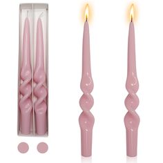 two pink candles are in a box and one is lit