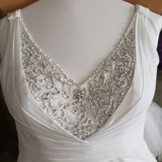 the back of a wedding dress with beading on it