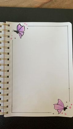 an open notebook with pink butterflies on it