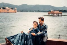 a man sitting next to a woman on top of a boat