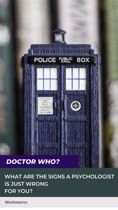 a blue police box sitting in front of books