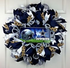 a wreath with the logo of the football team on it is hanging on a door