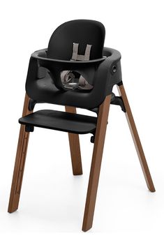 a black high chair with an infant seat